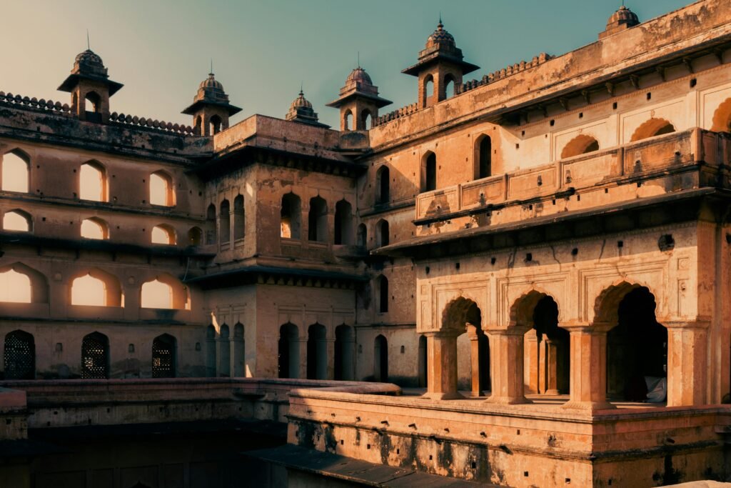 Capture of the iconic Raja Mahal showcasing Rajput architecture in Orchha, India at sunset.